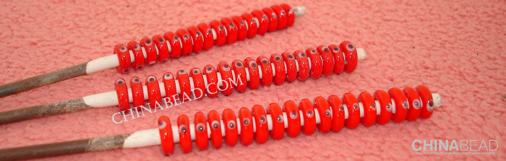 10mm x 3mm solid red with eye dots design lampwork spacer bead